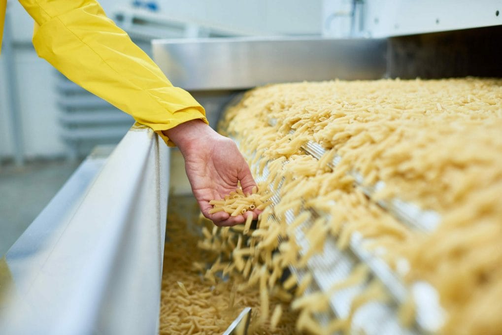 Spilling Macaroni in food processing factory